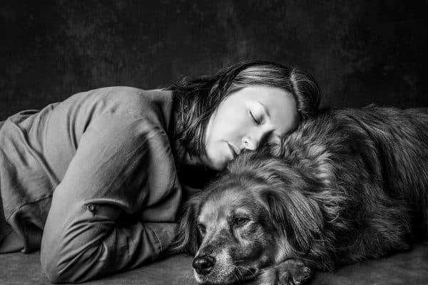 a black and white portrait of a woman with her older dog